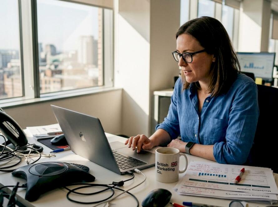 Manager tracking campaign results at desk